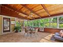 Bright sun room with tile floors, wood paneling, and a comfortable seating area at 4820 Coppedge Trl, Peachtree Corners, GA 30096