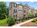 Charming townhome exteriors with brick facade, black shutters and decorative architectural details for upscale curb appeal at 2560 Clairebrooke Bnd, Atlanta, GA 30341