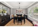 Formal dining room with dark wood table and chairs, and decorative mirror at 2921 Terra View Sw Dr, Lilburn, GA 30047