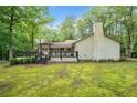 Scenic backyard featuring a deck, lush greenery, and a charming pergola for outdoor enjoyment at 3252 Custer Lake Drive Northwest Nw Dr, Marietta, GA 30064