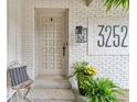 Inviting front entrance with white brick, a stylish light fixture, and a clear house number at 3252 Custer Lake Drive Northwest Nw Dr, Marietta, GA 30064