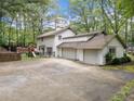 Spacious three-car garage with ample parking and an adjacent fenced play area for children at 3252 Custer Lake Drive Northwest Nw Dr, Marietta, GA 30064