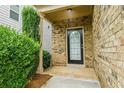 Inviting front door with brick facade and charming landscaping at 315 Lakeside Ln, Woodstock, GA 30188