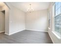 Dining room featuring wood floors, a chandelier, and two large windows for lots of natural light at 2709 Heathrow Dr, Lawrenceville, GA 30043