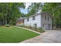 Bright home with an attached garage, lush lawn, and vibrant landscaping adding curb appeal at 5666 Fawn Dr, Powder Springs, GA 30127