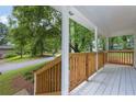 Inviting front porch with wooden railings and a view of the neighborhood street at 5666 Fawn Dr, Powder Springs, GA 30127