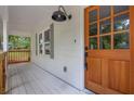 Close-up of a well-lit front porch featuring a wooden door with glass panels at 5666 Fawn Dr, Powder Springs, GA 30127