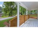 Inviting, covered porch with wooden railing, ideal for relaxing and enjoying the surrounding scenery at 5666 Fawn Dr, Powder Springs, GA 30127
