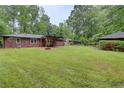 Expansive backyard with a covered patio, fire pit and plenty of open space at 122 Vickery Dr, Fairburn, GA 30213
