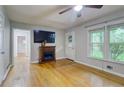Cozy living room with hardwood floors, a modern fireplace and ample natural light at 122 Vickery Dr, Fairburn, GA 30213