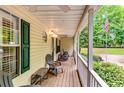 Relaxing porch with chairs, and white railings offering a view of the yard at 2200 E Lake E Rd, Mcdonough, GA 30252