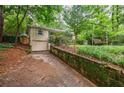 Lovely backyard featuring a swing and a garage accessed by a quaint stone-lined driveway at 4611 Dogwood Rd, Pine Lake, GA 30072