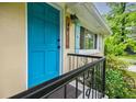 Close-up of the home's bright blue front door, featuring black hardware and a modern light fixture at 4611 Dogwood Rd, Pine Lake, GA 30072