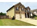 Side view of a two-story house showing a two-car garage and well-maintained lawn at 558 Hideaway Dr, Jonesboro, GA 30238