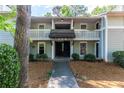 Two-story condo building with balconies and stairs, surrounded by lush greenery at 603 Summit North Ne Dr # 603, Atlanta, GA 30324