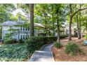 Scenic view of condo building with walking path and mature trees at 603 Summit North Ne Dr # 603, Atlanta, GA 30324