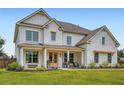 Elegant home with brick and siding exterior, showcasing a covered porch, and meticulously maintained lawn at 6168 Sweet Birch Ct, Acworth, GA 30101