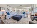 Bright, open living space with modern decor, plush seating, and seamless flow to kitchen at 6168 Sweet Birch Ct, Acworth, GA 30101