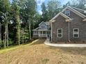 Beautiful new two-story home showcasing stone details and a manicured front yard at 1119 Plantation Se Dr, Conyers, GA 30094