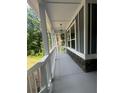 Covered front porch with white railings and stone accents provides a welcoming outdoor space at 1119 Plantation Se Dr, Conyers, GA 30094