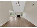 Bright, airy living room with high ceilings, fireplace, and stylish flooring at 164 Gleneagles Way, Fayetteville, GA 30215