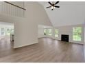Bright, airy living room with high ceilings, fireplace, and stylish flooring at 164 Gleneagles Way, Fayetteville, GA 30215