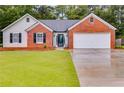 Charming single-story brick home with well-kept lawn and a two-car garage at 4490 Epworth Court Ct, Powder Springs, GA 30127
