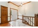 Welcoming foyer with tile flooring, wooden trim, and a chandelier, leading to the main areas of the home at 48 Saddle Field Nw Cir, Cartersville, GA 30121