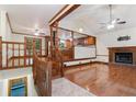 Bright living room with hardwood floors, a brick fireplace, and a partial view of the kitchen at 48 Saddle Field Nw Cir, Cartersville, GA 30121