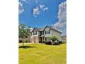 Well-maintained home with landscaped front yard, two-car garage, and charming curb appeal at 520 Harmony Way, Locust Grove, GA 30248