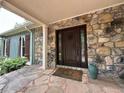 Elegant stone entryway with a carved wooden front door and decorative accents at 722 Beauregard Sw Dr, Marietta, GA 30064