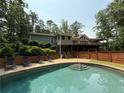 Backyard with a sparkling pool, lounge chairs, and a wooden fence for privacy at 722 Beauregard Sw Dr, Marietta, GA 30064