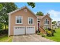 Charming two-story home with a well-manicured lawn and a two-car garage at 920 Highfield Ct, Lawrenceville, GA 30043