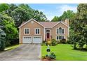 Beautiful two-story home with a red front door and lush green lawn at 920 Highfield Ct, Lawrenceville, GA 30043