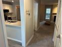 Galley kitchen featuring white cabinets, stainless appliances, and a view into the living space at 1130 Weatherstone Ne Dr, Atlanta, GA 30324