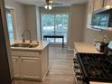 Bright eat-in kitchen with stainless appliances, quartz countertops, and view of backyard at 1130 Weatherstone Ne Dr, Atlanta, GA 30324