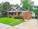 Classic brick home with inviting front porch, mature trees, and a convenient driveway at 147 Olympic Pl, Decatur, GA 30030