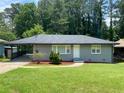 Charming single-story home with a well-manicured lawn and a covered driveway at 2107 Garden Cir, Decatur, GA 30032
