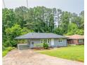 Well-kept home with a spacious front yard, driveway, and lush trees at 2107 Garden Cir, Decatur, GA 30032