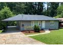 Charming gray home features a lush, well-manicured lawn and welcoming entrance with tasteful landscaping at 2107 Garden Cir, Decatur, GA 30032