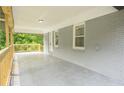 Covered porch with a view of the backyard, painted brick and wood railings at 2107 Garden Cir, Decatur, GA 30032