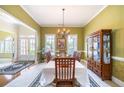 Bright dining room with large windows, chandelier, and doorway to living room at 1997 Shaker Falls Ln, Lawrenceville, GA 30045