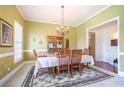 Bright dining room featuring a chandelier, decorative rug and ample space for entertaining at 1997 Shaker Falls Ln, Lawrenceville, GA 30045