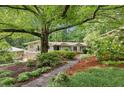 Beautiful home with mature trees and landscape, highlighted by a stone walkway at 2481 Melinda Ne Dr, Atlanta, GA 30345