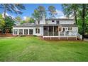 Expansive backyard with a deck, screened-in porch, and sunroom, perfect for outdoor living at 4333 Collingham Ne Trce, Marietta, GA 30068