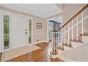 Inviting foyer with hardwood floors, staircase, and view into another living area at 4333 Collingham Ne Trce, Marietta, GA 30068