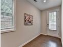 Bright entryway featuring hardwood floors, fresh paint, decor art, and a door to the outside at 747 Topsail Ln, Alpharetta, GA 30005