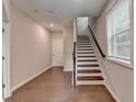 Bright entryway with hardwood floors and a staircase leading to the upper level at 747 Topsail Ln, Alpharetta, GA 30005