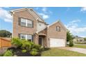 Beautiful two-story brick home featuring a manicured lawn, stone accents and a spacious two-car garage at 1504 Lemon Balm Ct, Lawrenceville, GA 30045