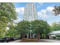 A modern high-rise building with lush landscaping and mature trees at 2870 Pharr Court South Nw # 1704, Atlanta, GA 30305